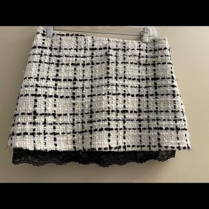 Wool mini skirt black and cream accented size 2 with black lace hem at bottom